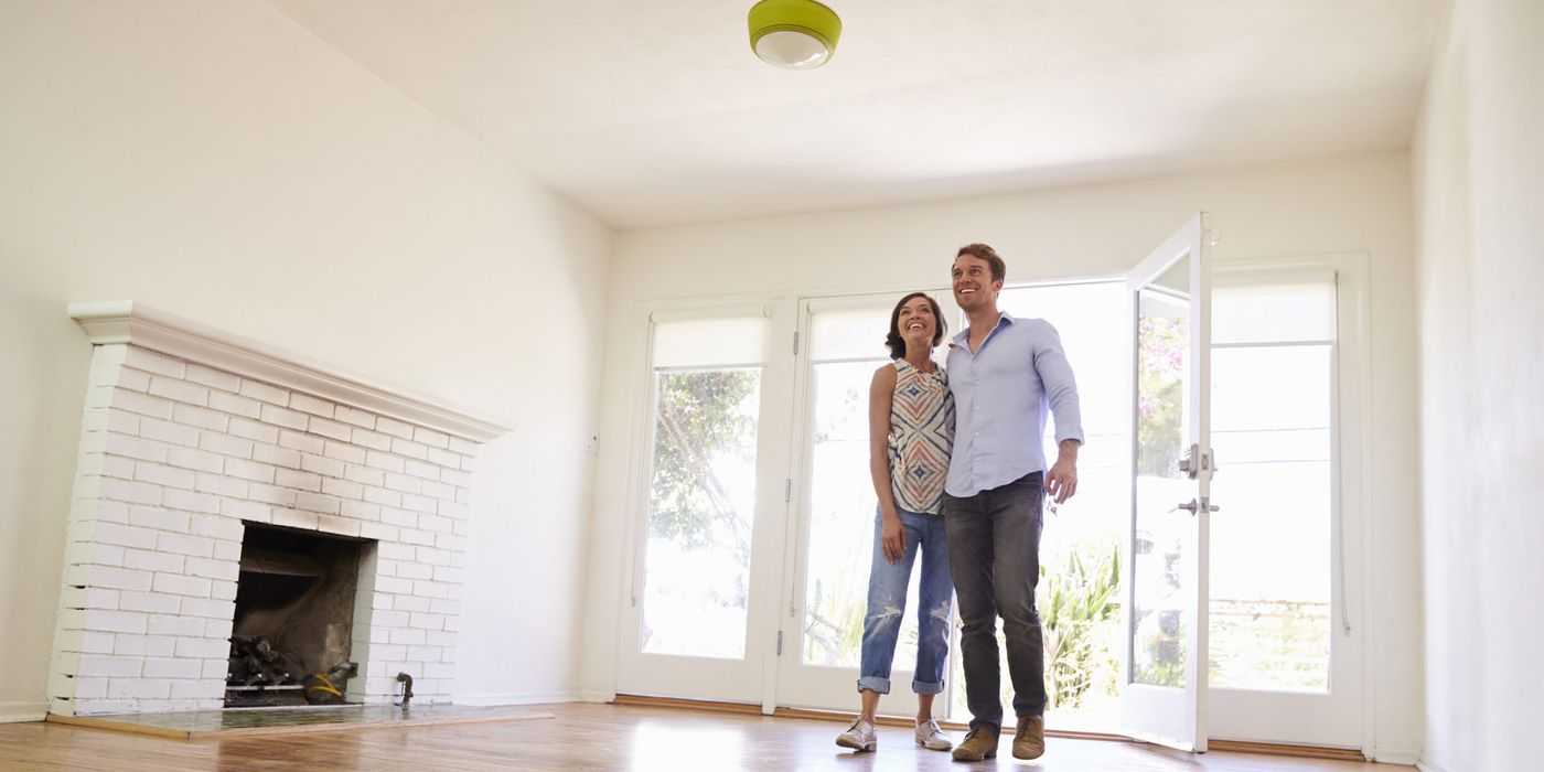 couple in vacation rental interior depicting smart device management and SmartRent alternatives