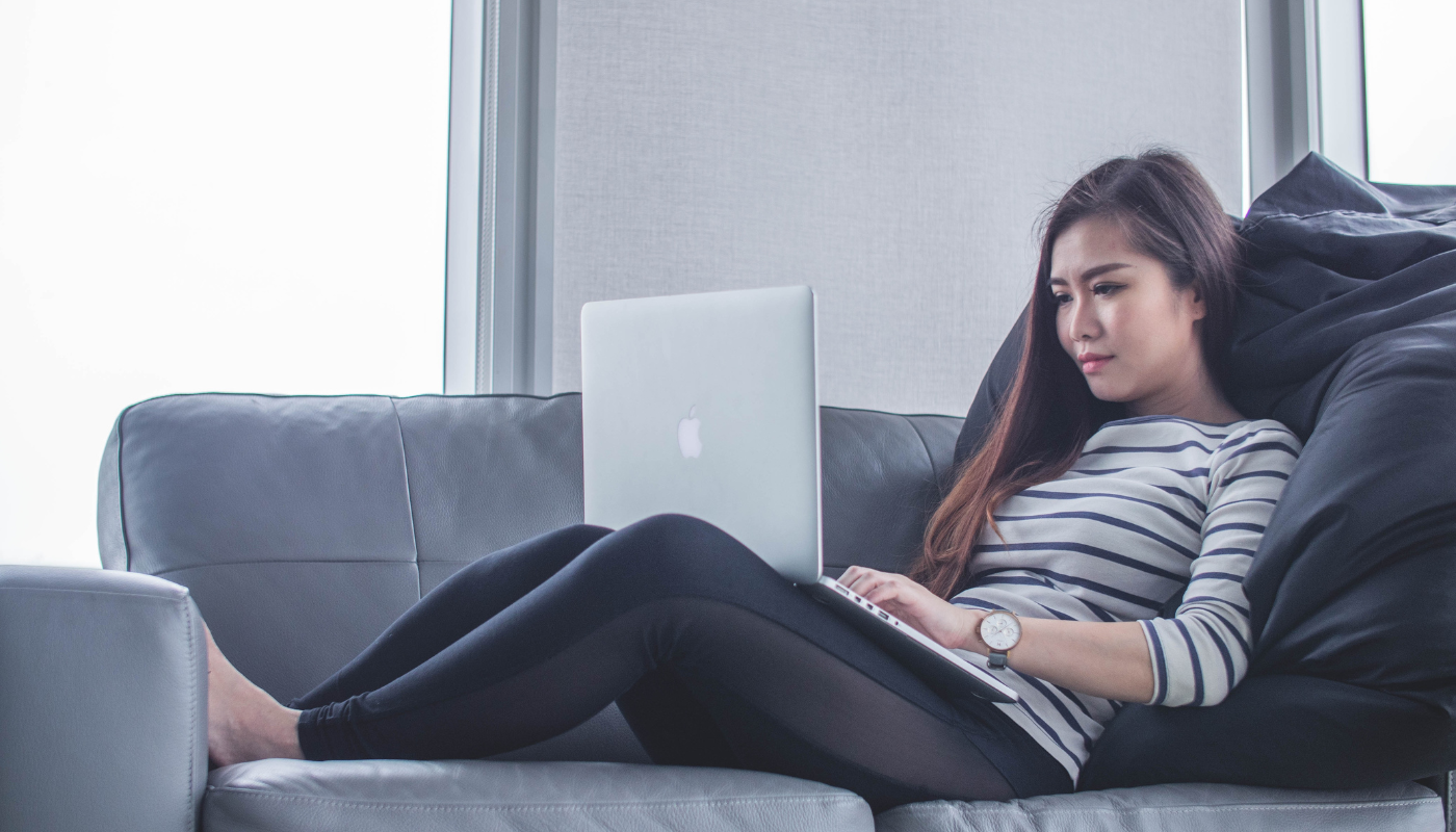 girl on couch communicating on computer depicting resident communication